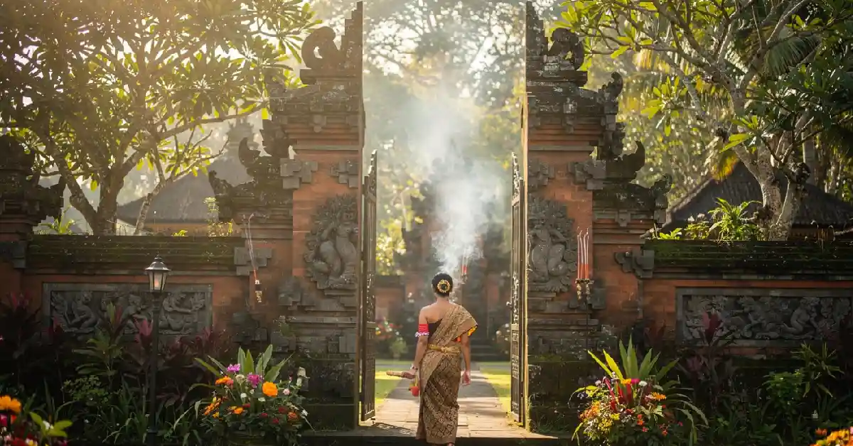 Essential Bali temple etiquette - Woman wearing sarong entering a traditional Balinese temple