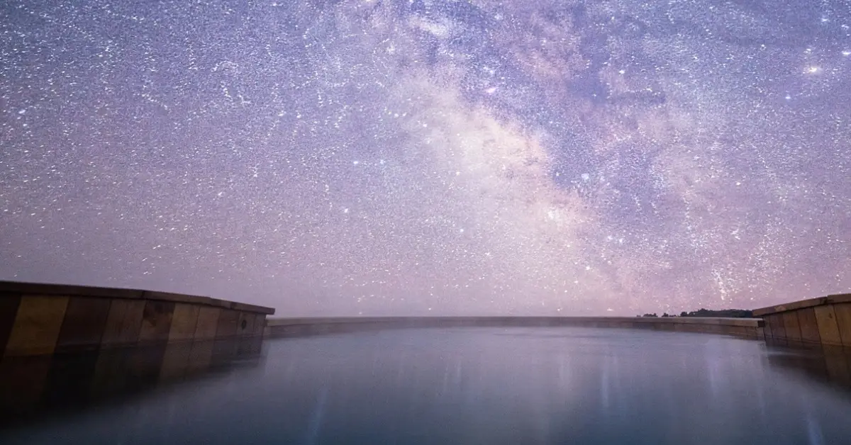 Stunning night sky with bright Milky Way galaxy viewed from a hot spring in Harney County Oregon.