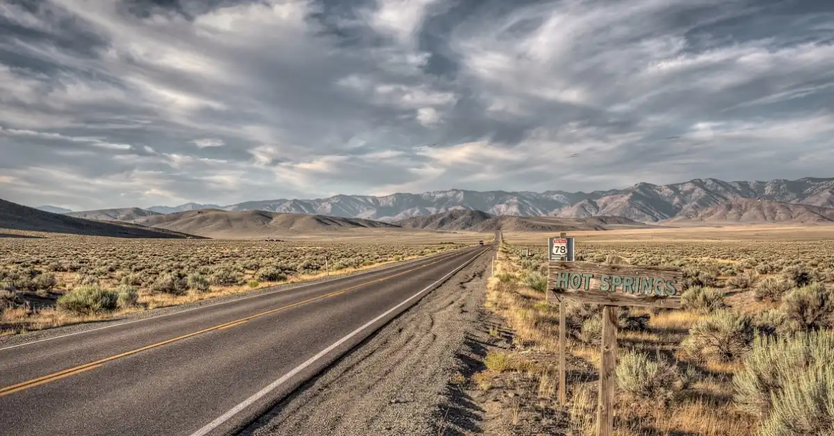 Long empty two lane highway 78 stretching through the remote high desert of eastern Oregon leading to Crystal Crane Hot Springs.